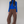 Charger l&#39;image dans la galerie, woman standing against beige backdrop wearing a cobalt blue turtleneck and brown straight-leg, low-rise sweatpants. paired with black sneakers. Long brown straight hair and fair skin. 
