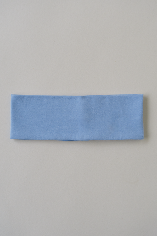 baby blue cotton headband laying on a beige surface