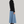 Load image into Gallery viewer, woman standing wearing a black turtleneck and long blue maxi skirt and maroon boots
