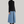 Charger l&#39;image dans la galerie, woman standing with black short hair. wearing a black fitted long-sleeve turtleneck and long blue denim skirt and maroon high heel boots
