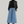 Charger l&#39;image dans la galerie, woman standing relaxed wearing a leather jacket, black turtleneck and long blue denim skirt and black boots
