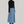 Charger l&#39;image dans la galerie, A woman with short black hair wearing a comfortable and chic long-sleeve black turtleneck and a stylish long blue denim skirt, paired with black boots. This beautifully crafted clothing is proudly made in Montreal.&quot;
